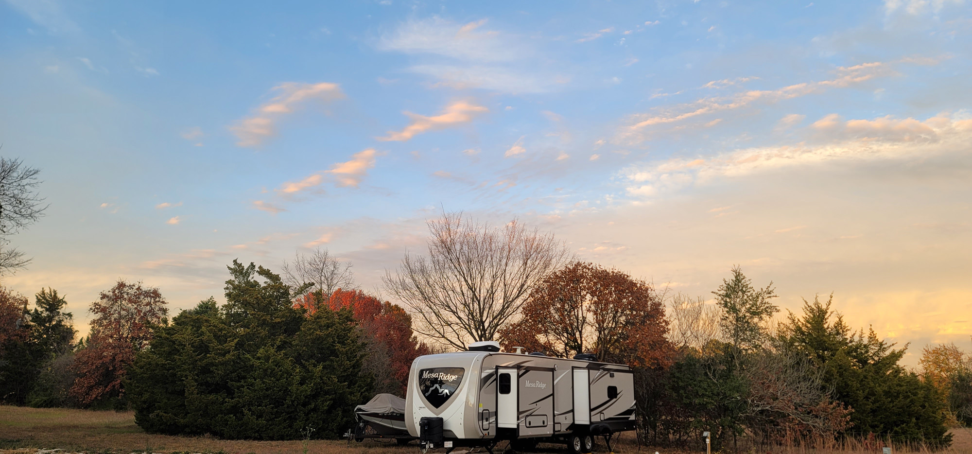 RV in Park by Juniper and Oak Trees